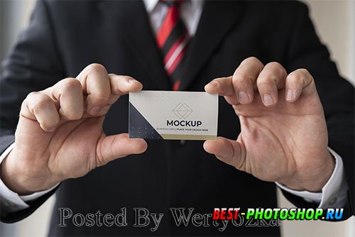 Close-up businessman holding business card mock-up with both hands